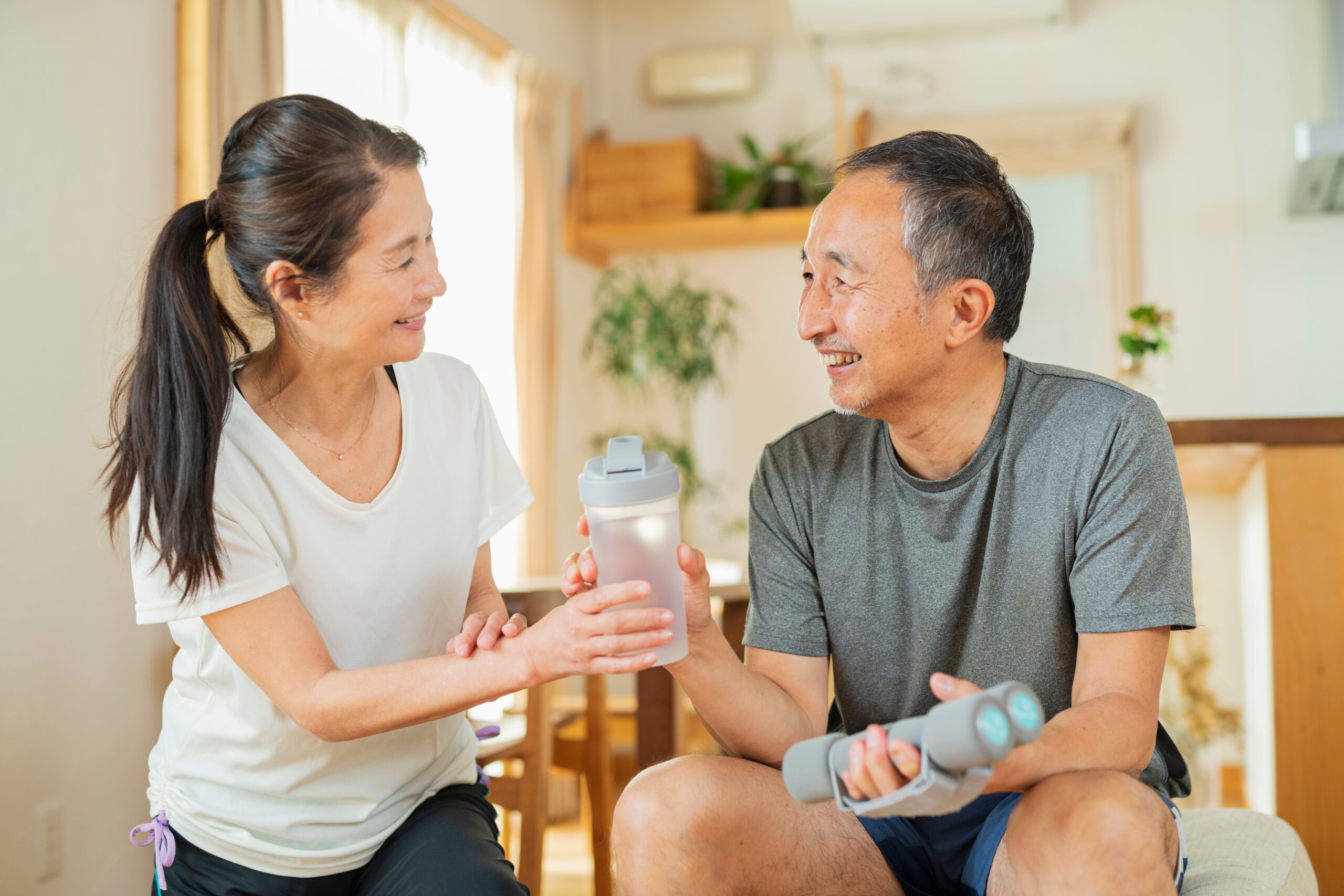 室内で運動するシニア夫婦