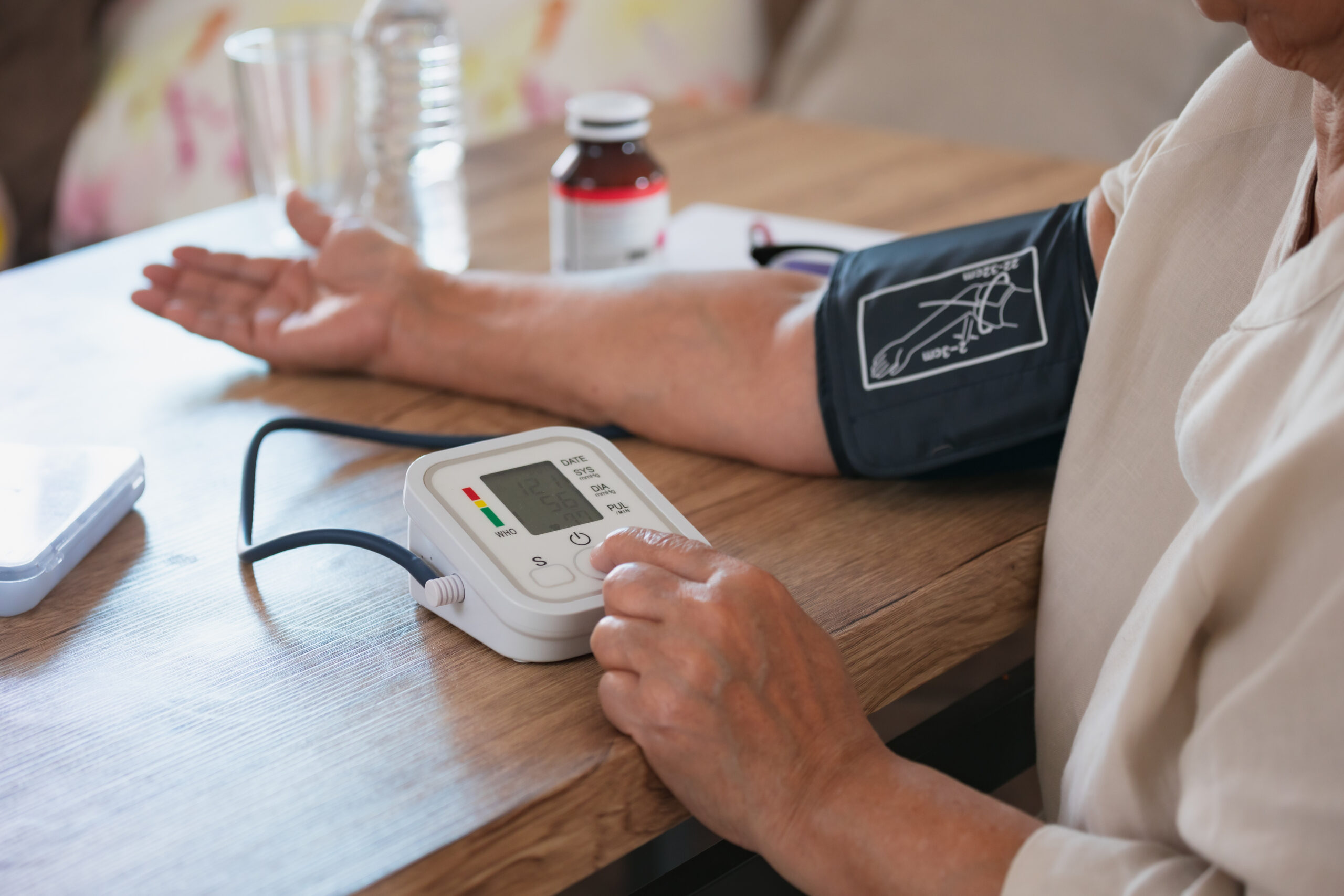 Senior woman is checking blood pressure and heart rate with digital pressure gauge by herself at home.Older woman taking care for health. Health and Medical concept.