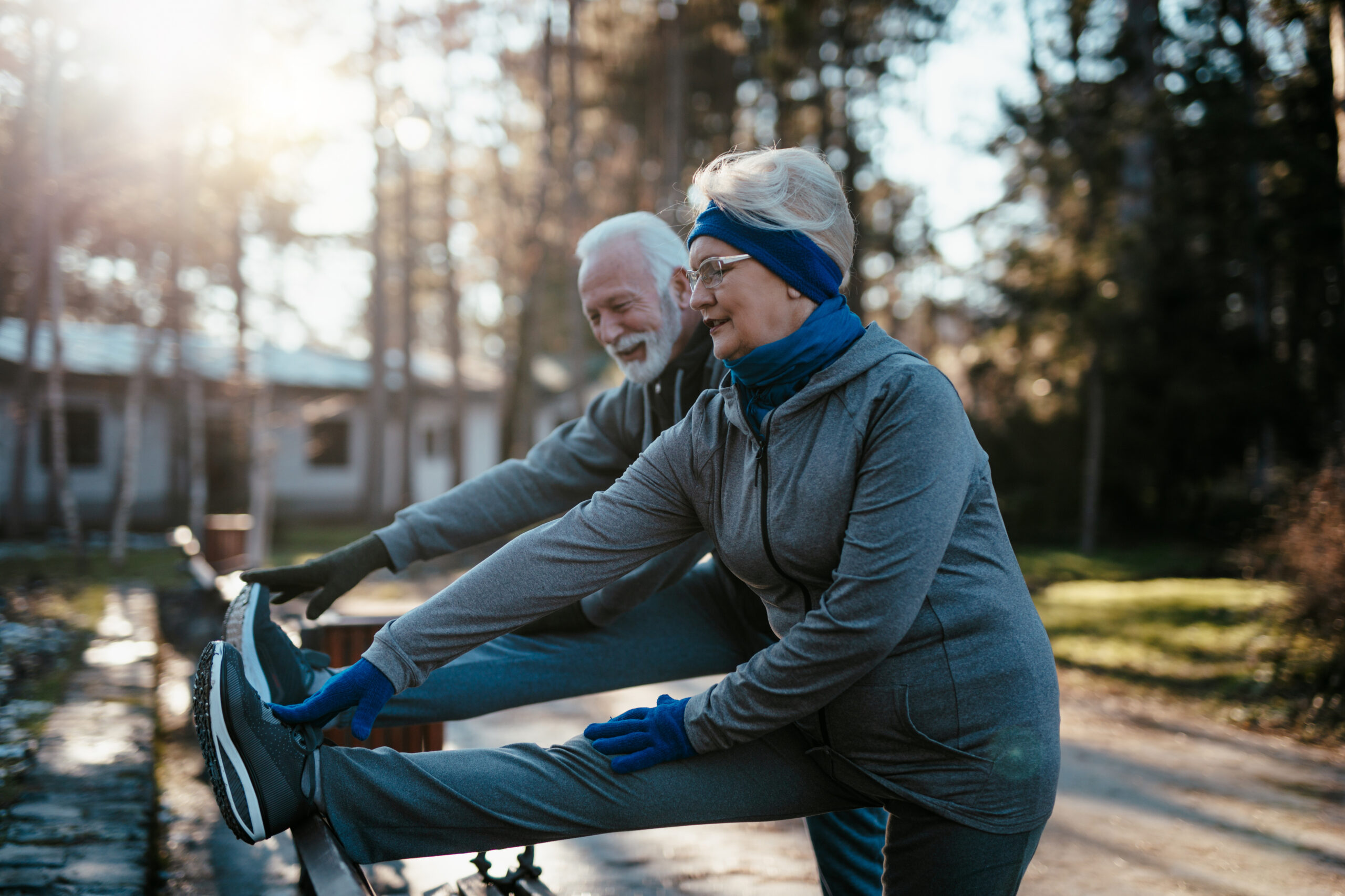 An older married couple enjoys exercising and jogging on a beaut